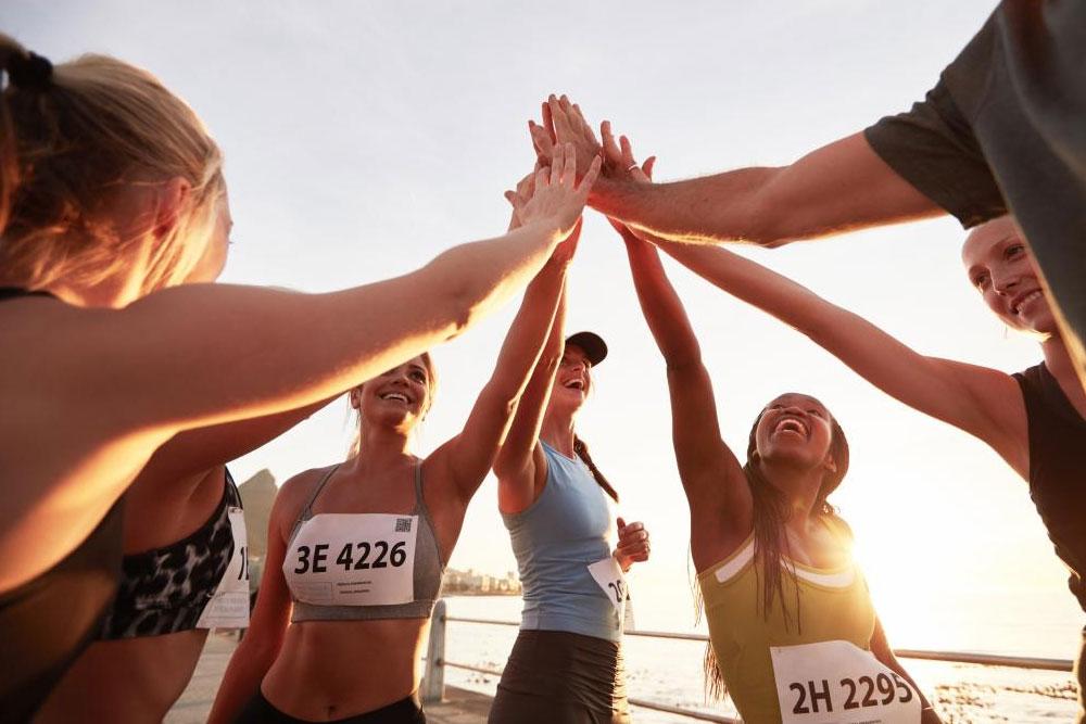 Happy young people on beach high fiving