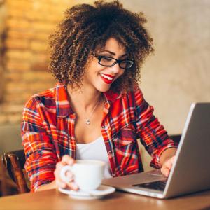 Lady having coffee at laptop