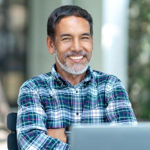 Older man behind laptop