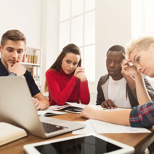 Employee group watching video on laptop