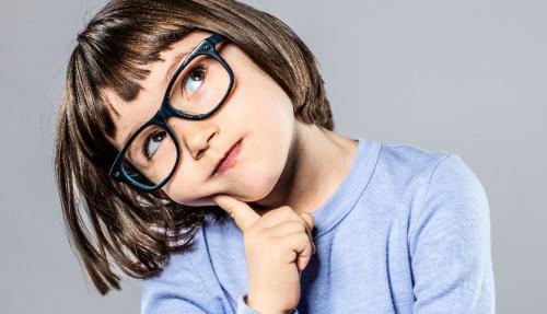 Young girl with glasses pondering life hand on chin