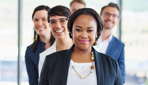Group of professionals lined up behind a black lady