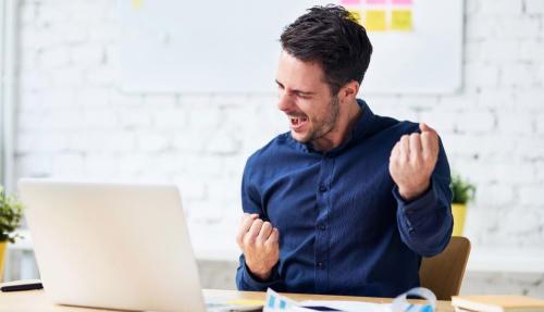 Happy man at home office desk