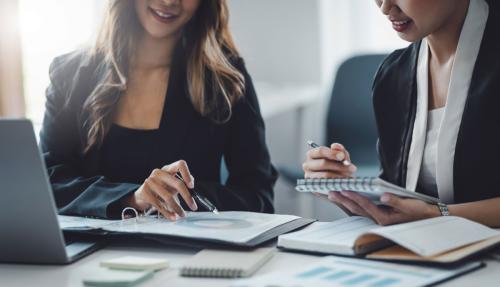 Male and female professionals working at desk