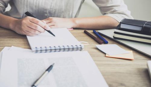 Closeup of office desk with notepad