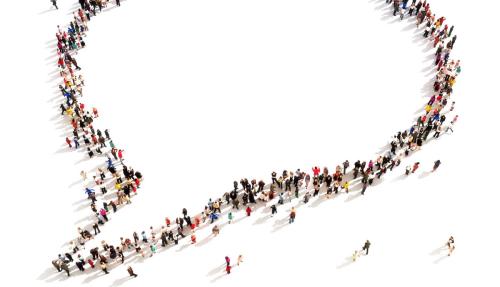 Concept of 100s of people forming a speech bubble shape