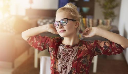 Lady chilling out having a coffee stretching arms