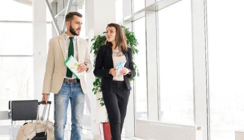 Man and lady walking together in large room