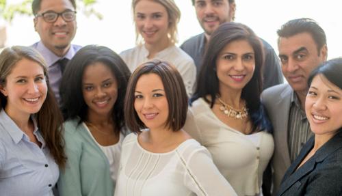 Multicultural group of employees huddled together