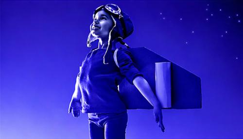 Child with wings pretending takeoff dark purple background