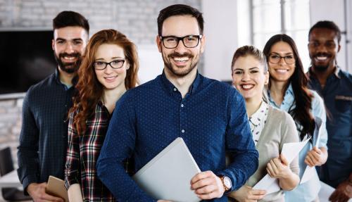 Group of young professionals with young man front and centre